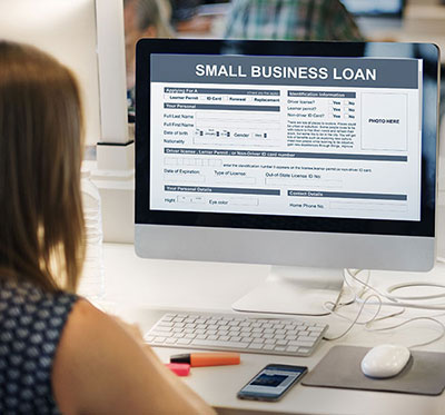 Woman Looking at Computer PPP Loan Application