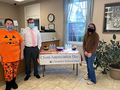 Elizabethtown Employees Standing Next to Halloween Table of Treats