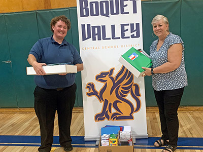 Megan and Lena Holding Boxes of Folders and School Supplies