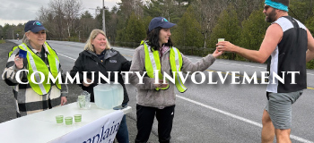 Three Women handing out Water to Runners