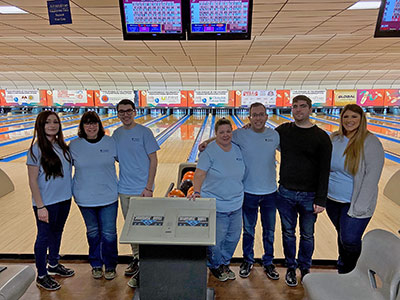 Seven People Standing in front of bowling lanes