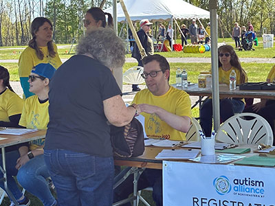 Brian Ellsworth Helping a Woman Register at a Table