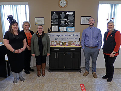 Willsboro Employees Standing Next to Halloween Table of Treats