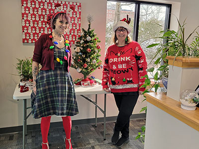 Two People Wearing Holiday Sweaters