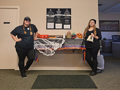 Macie and Autumn wearing a police and bank robber costume